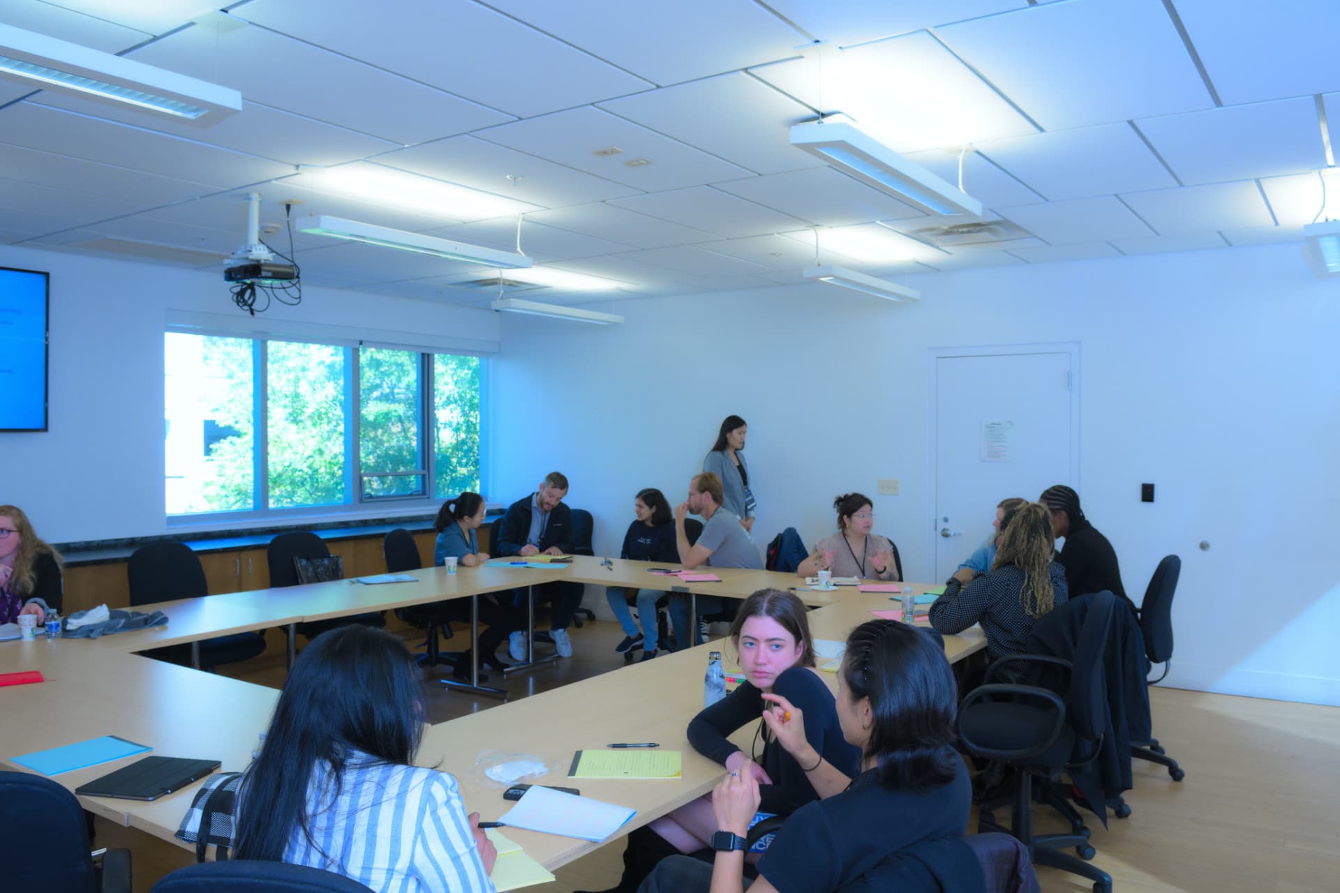 Facilitators and participants working together at a UXU workshop table